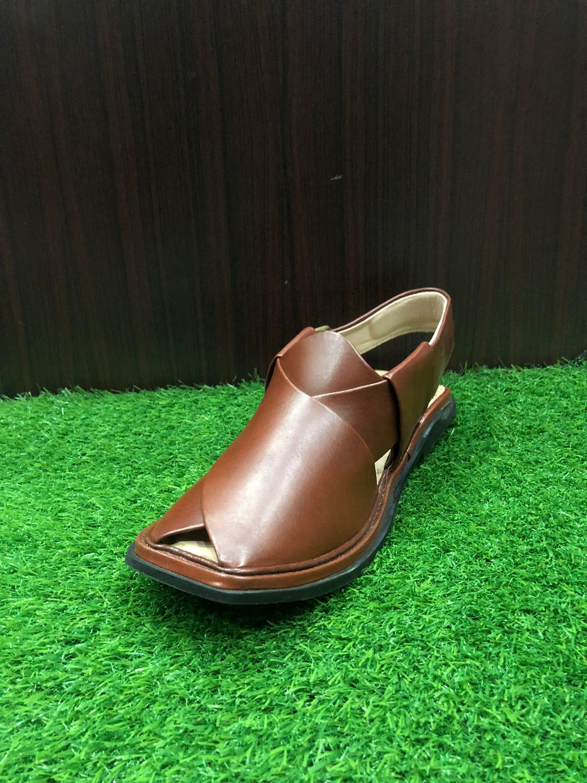 "Traditional Peshawari Chappal made from high-quality leather, with a cross-strap design and a padded footbed, representing the craftsmanship of artisans from Pakistan."

