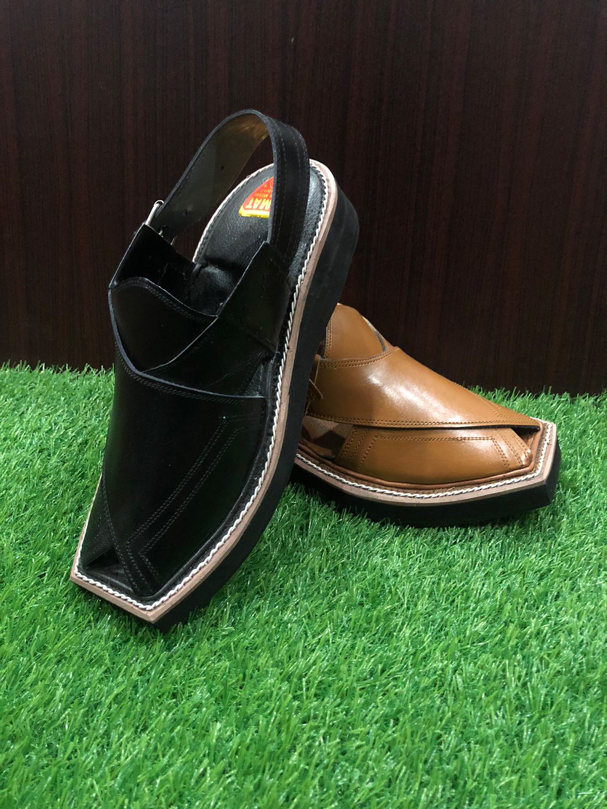 "A pair of classic brown leather Peshawari Chappals, designed with intricate hand-stitched patterns and a traditional open-toe style, popular in Pakistani culture."