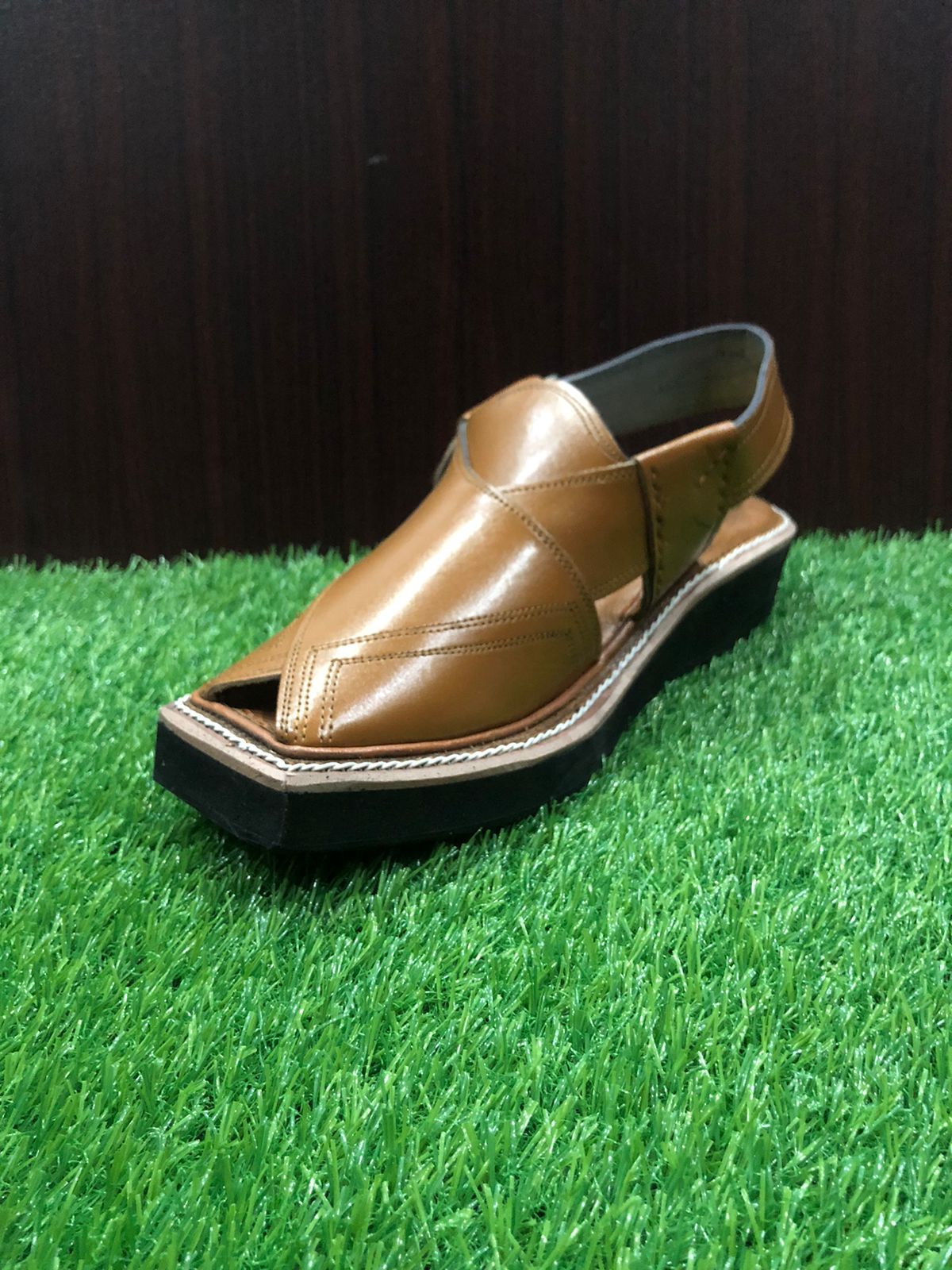 A high-quality Peshawari Chappal made from brown leather, showcasing a stylish yet comfortable design with detailed craftsmanship, perfect for both casual and formal wear."