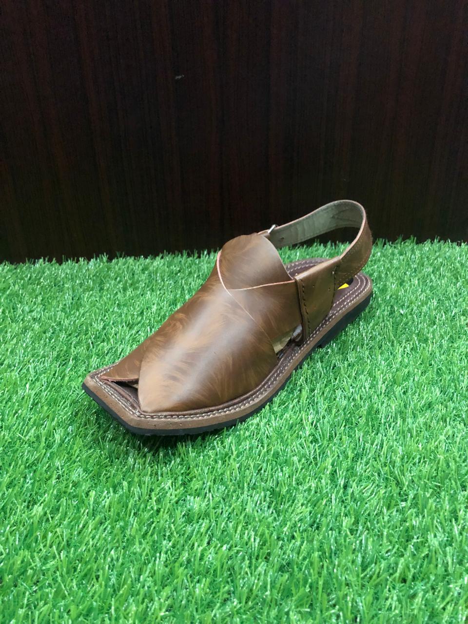 "Authentic Peshawari Chappal in rich brown leather, showcasing the iconic wide V-shaped strap and durable stitching, blending traditional style with modern comfort."